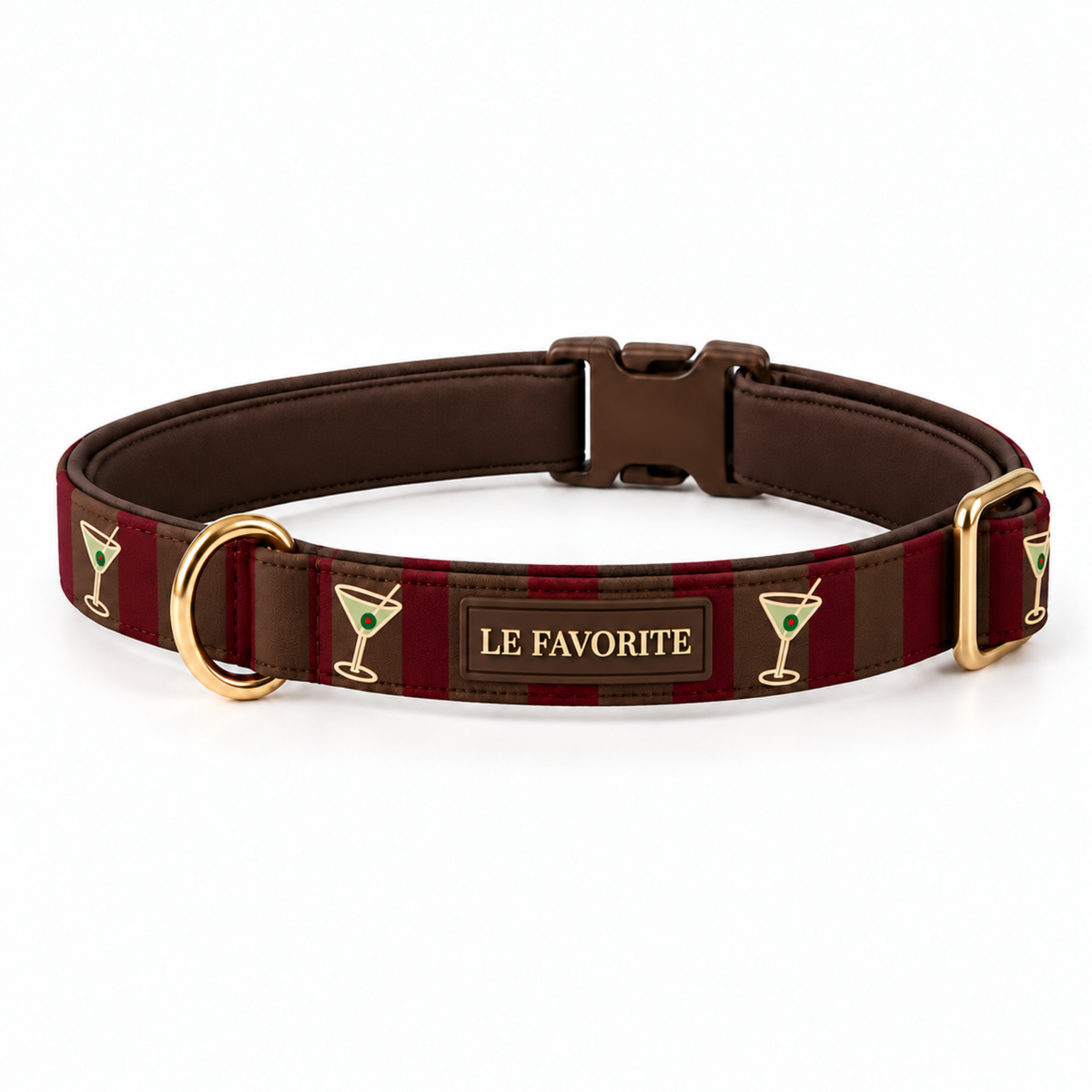 A brown leather dog collar with red and brown stripes, featuring gold-tone hardware, a central plaque that reads 'LE FAVORITE', and small martini glass icons on a white background.