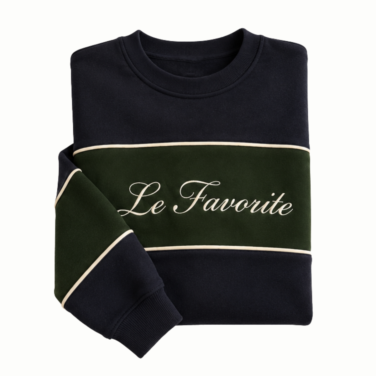 A folded crewneck sweatshirt in black and dark green with cream-colored stripes and the text 'Le Favorite' printed across the chest, shown on a plain white background.