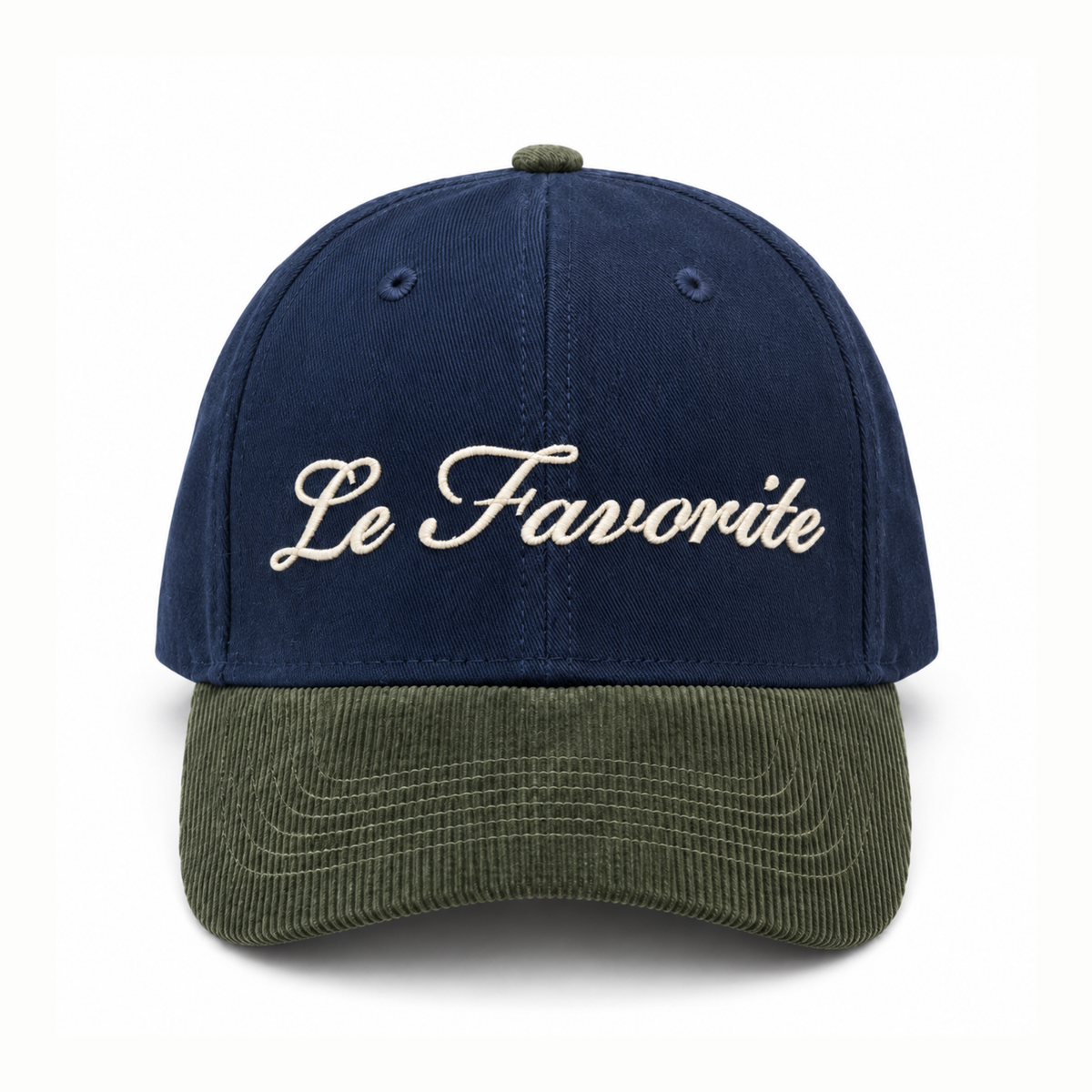 A baseball cap with a navy blue crown and an olive green corduroy brim, featuring the phrase 'Le Favorite' embroidered in cream cursive across the front.